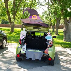 a car with its trunk open and decorations on the back