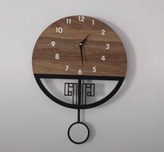 a clock that is hanging on the wall with numbers and symbols in front of it