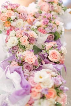 wedding bouquets lined up in rows on the floor at a ceremony or reception venue