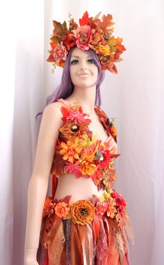 a female mannequin with flowers and leaves on her body