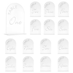 twelve white plastic tombstones with the names of each grave and one for each other