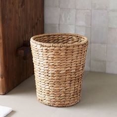 a basket sitting on the floor next to a door