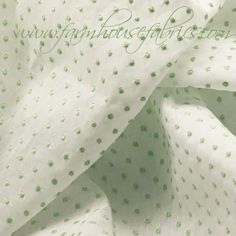 white and green fabric with small dots on it