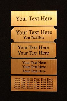 three gold plaques with text on them in the shape of four rectangles against a black background