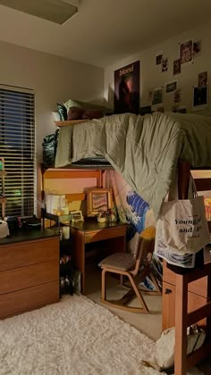 a dorm room with a bed, desk and chair