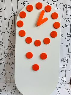 a clock made to look like a snowman with carrots on it's face