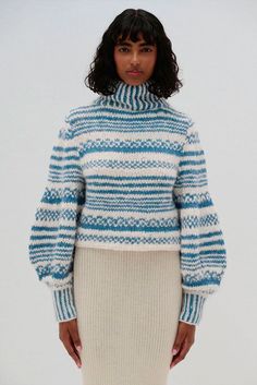 This luxurious sweater is made from a beautiful blend of alpaca and cotton, crafted with sustainability and comfort in mind. This hand-knit masterpiece features a rich stripe design, available in two sophisticated color combinations, with voluminous sleeves, making it the perfect statement piece for the colder seasons. It features a high, ribbed turtleneck that offers cozy warmth while elongating the neck for a sophisticated silhouette. The natural softness of alpaca paired with the durability of cotton ensures warmth, breathability, and a unique textured feel. Ribbed turtleneck for warmth and a chic, elongated neckline Chunky, handknit texture with bold horizontal stripes Voluminous balloon sleeves add a modern, oversized look Cropped silhouette ideal for pairing with high-waisted styles Yarn For Sale, Voluminous Sleeves, Alpaca Sweater, Poncho Tops, High Waist Fashion, Ribbed Turtleneck, Horizontal Stripes, Cold Season, Mens Pajamas