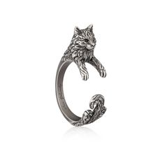 a silver ring with a cat on it's head and claws in the middle