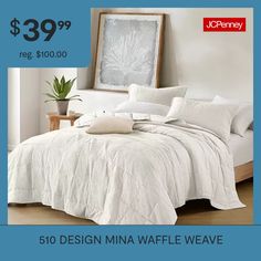 a bed with white comforter and pillows on it for $ 39 99 reg $ 100 00