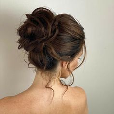 a woman with her hair in a low bun