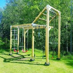 a wooden swing set in the middle of a park