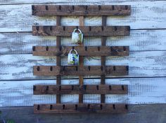 a pair of shoes is hanging on a wooden rack with pegs in the shape of a christmas tree