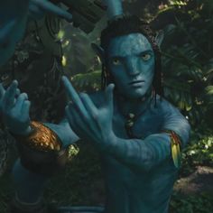 the avatar from avatar is holding his hands up in front of him and pointing to something