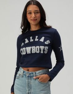 Dallas Cowboys Long Sleeve Baby Tee. Show Your Team Pride With This Dallas Cowboys Long Sleeve Baby Tee. Featuring "dallas Cowboys" Screened Across The Front Chest And A Bold Star Graphic On The Left Sleeve, This Fitted Tee Is Perfect For Fans Looking For A Stylish And Sporty Look. Ideal For Game Day Or Casual Wear! 94% Cotton, 6% Spandex. Machine Wash. Imported. Model Is Wearing A Size Small. Model Measurements:height: 5'8" Bust: 32"waist: 24"hips: 35" Blue Fitted Tops For College, Game Day Long Sleeve Top With Graphic Print, Game Day Long Sleeve Graphic Print Top, Collegiate Style Fitted Tops For Spring, Collegiate Style Tops With Text Print For Spring, Collegiate Style Text Print Tops For Spring, Blue Tops For Spring School Spirit, Blue Spring Tops For School Spirit, Blue Spring Tops With School Spirit Style