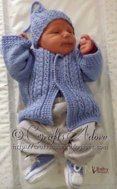 a baby wearing a blue knitted sweater and hat