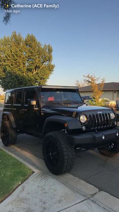 a black jeep is parked in front of a house