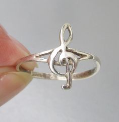 This vintage 1980s sterling silver unisex ring has a 5/8" long treble clef on a plain narrow size 9 band.  It is marked 925 for sterling and is in excellent condition with no wear or damage.  It can be resized up or down several sizes by your jeweler.    FREE SHIPPING within the USA and it will arrive gift boxed.    1165 Treble Clef, Unisex Ring, Solitaire Ring, Musician, Jewelry Rings, Ring Size, Vintage Fashion, Accessory Gift, Electronic Accessories