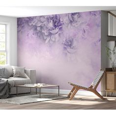 a living room scene with focus on the sofa and wallpaper that has been painted in shades of lilac