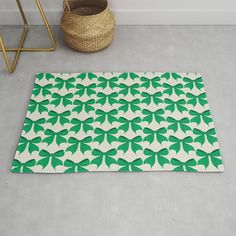 a green and white rug on the floor next to a basket with a wicker basket