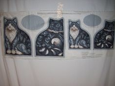 three pictures of cats are hanging on the wall in front of a white curtain with black and grey designs