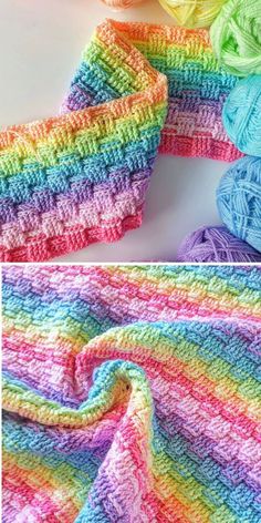 crocheted rainbow blanket with yarn on top and the same color as it is