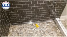 a tile shower stall with coins on the floor