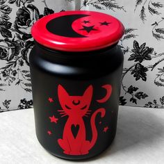 a black and red canister with a cat on it