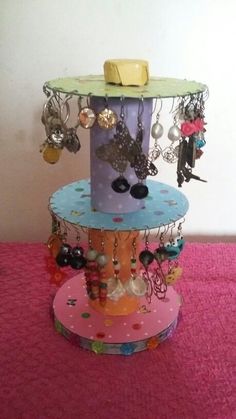 a three tiered display with earrings on it