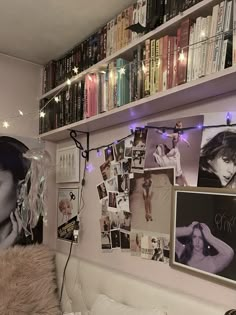 a bed room with a neatly made bed and lots of books on the shelves above it