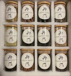 twelve jars filled with different types of spices