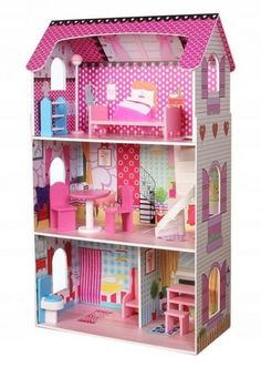 a pink doll house with furniture and accessories on the inside is shown in full view