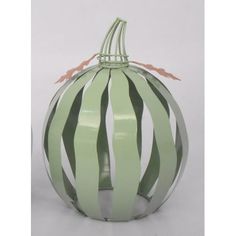 a green and white striped glass pumpkin