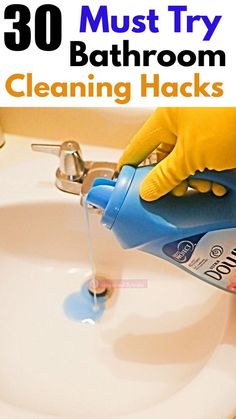 a person in yellow gloves is cleaning a sink with a blue sprayer and the words 30 must try bathroom cleaning hacks