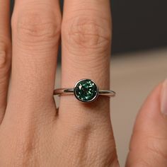 This is a gorgeous handmade creation. Its beauty is its simplicity & Elegance. The 7*7mm round cut lab green sapphire is crafted in solid sterling silver / 14k gold. It is available to customized, if you have any mind, just let me know, we will discuss with it. All item is sent in a beautiful gift box You can realize more lovely stuff clicking the link https://www.etsy.com/shop/knightjewelry?refshopsection_shophome_leftnav Please leave the correct address and you PHONE NUMBER for delivering Elegant Emerald Ring With Tension Setting For May Birthstone, Classic Green Bezel Set Birthstone Ring, Sterling Silver Round Solitaire Jewelry, Classic Green Birthstone Ring With Bezel Setting, Classic Sterling Silver Birthstone Ring With Tension Setting, Classic Sterling Silver Emerald Ring With Round Band, Everyday Solitaire Emerald Jewelry, White Gold Emerald Ring With Bezel Setting, Elegant May Birthstone Jewelry With Tension Setting