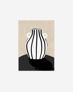 a black and white vase sitting on top of a table