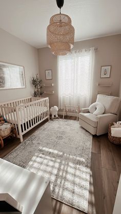 a baby's room with a crib, rocking chair and large rug on the floor