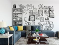 a living room with couches, tables and pictures on the wall behind them in black and white