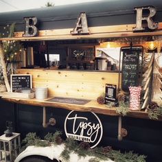 a food truck is decorated for christmas with pine cones and evergreens on the counter