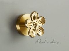 a close up of a flower shaped knob on a wall