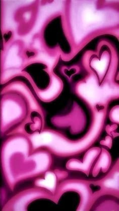 some pink and black hearts in the middle of a wallpaper pattern, with one heart on it's left side