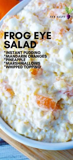 a bowl filled with food on top of a wooden table next to an orange and white napkin