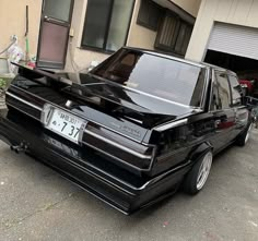 a black car parked in front of a building