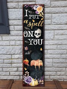 a wooden sign that says i put a spell on you with a cow and pumpkins