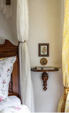 a bed room with a neatly made bed and curtains