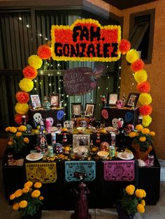 a table with decorations and pictures on it for a halloween themed party or celebration in front of a building