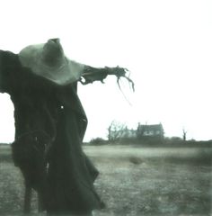 an old photo of a person in a field