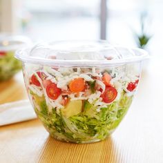 a salad in a plastic container sitting on a table