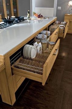 an open drawer in the middle of a kitchen counter