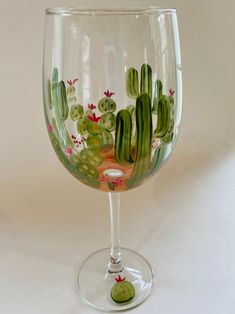 a wine glass with cactus designs on it