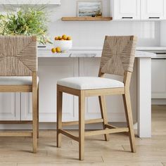 two chairs sitting in front of a kitchen counter